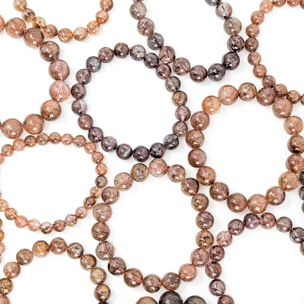 Copper rutile in quartz bead bracelet from Brazil – overlapping bracelets, wider view