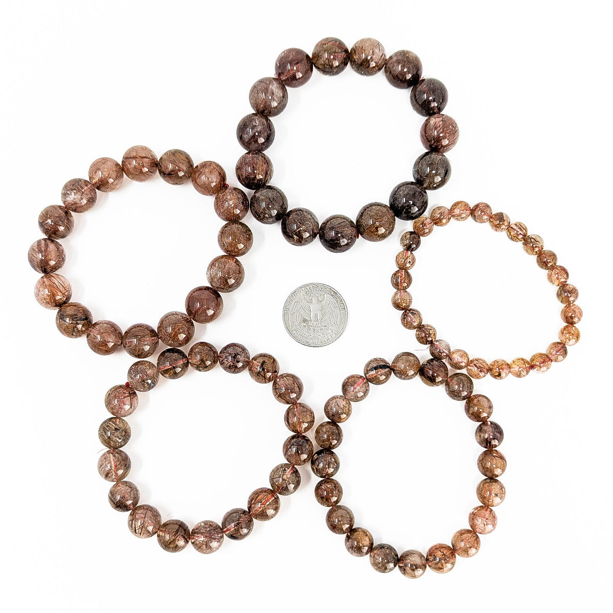 Copper rutile in quartz bead bracelet from Brazil – five bracelets around a coin for scale