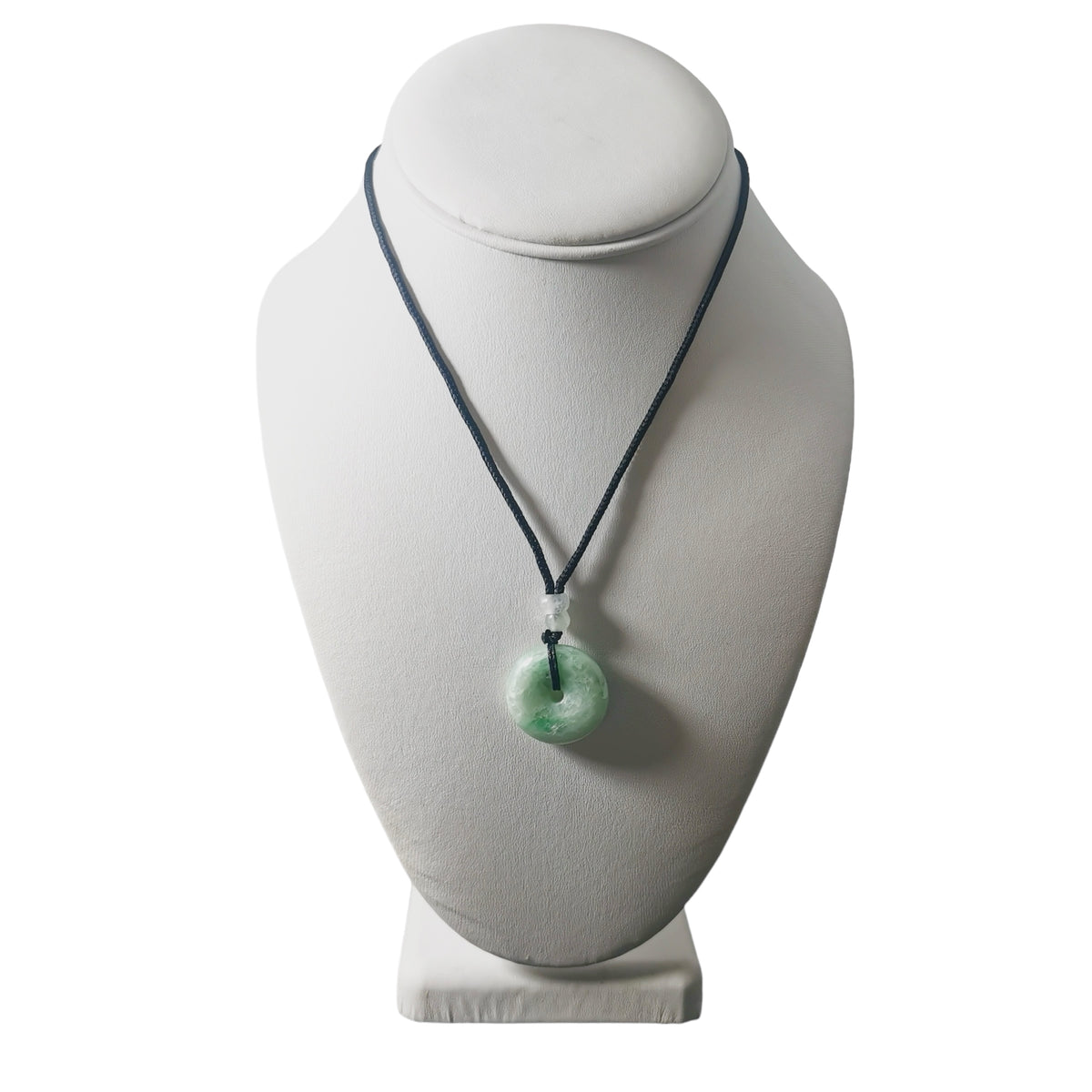 Jadeite bi-disc necklace: necklace on a display