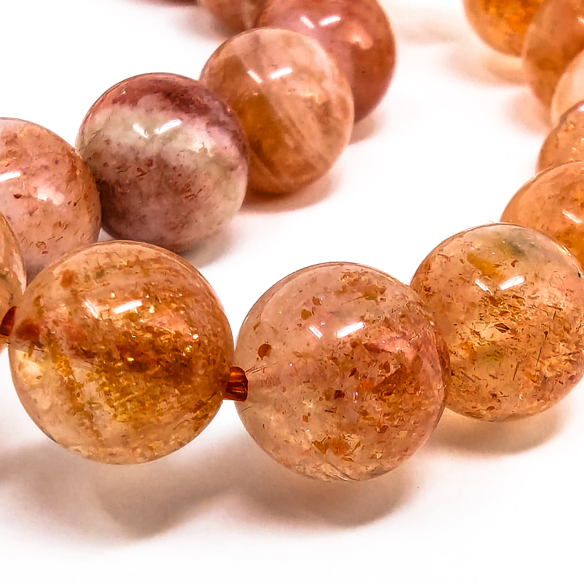 Orange Specular Sunstone round bead bracelet.