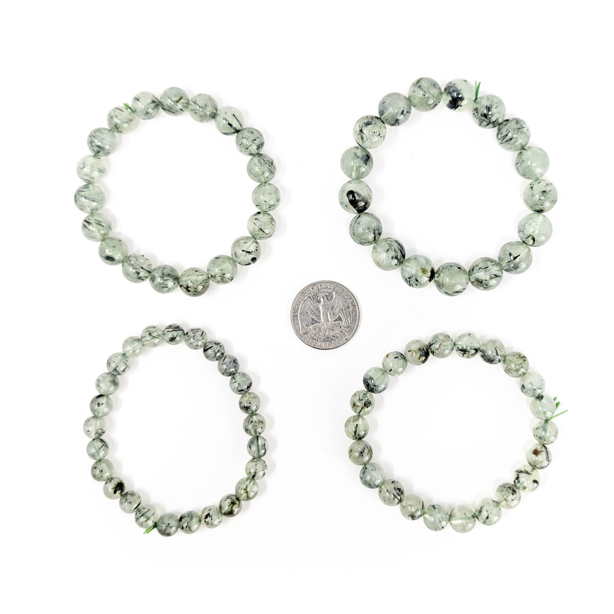 Prehnite with tourmaline bracelet: bracelet beside a coin