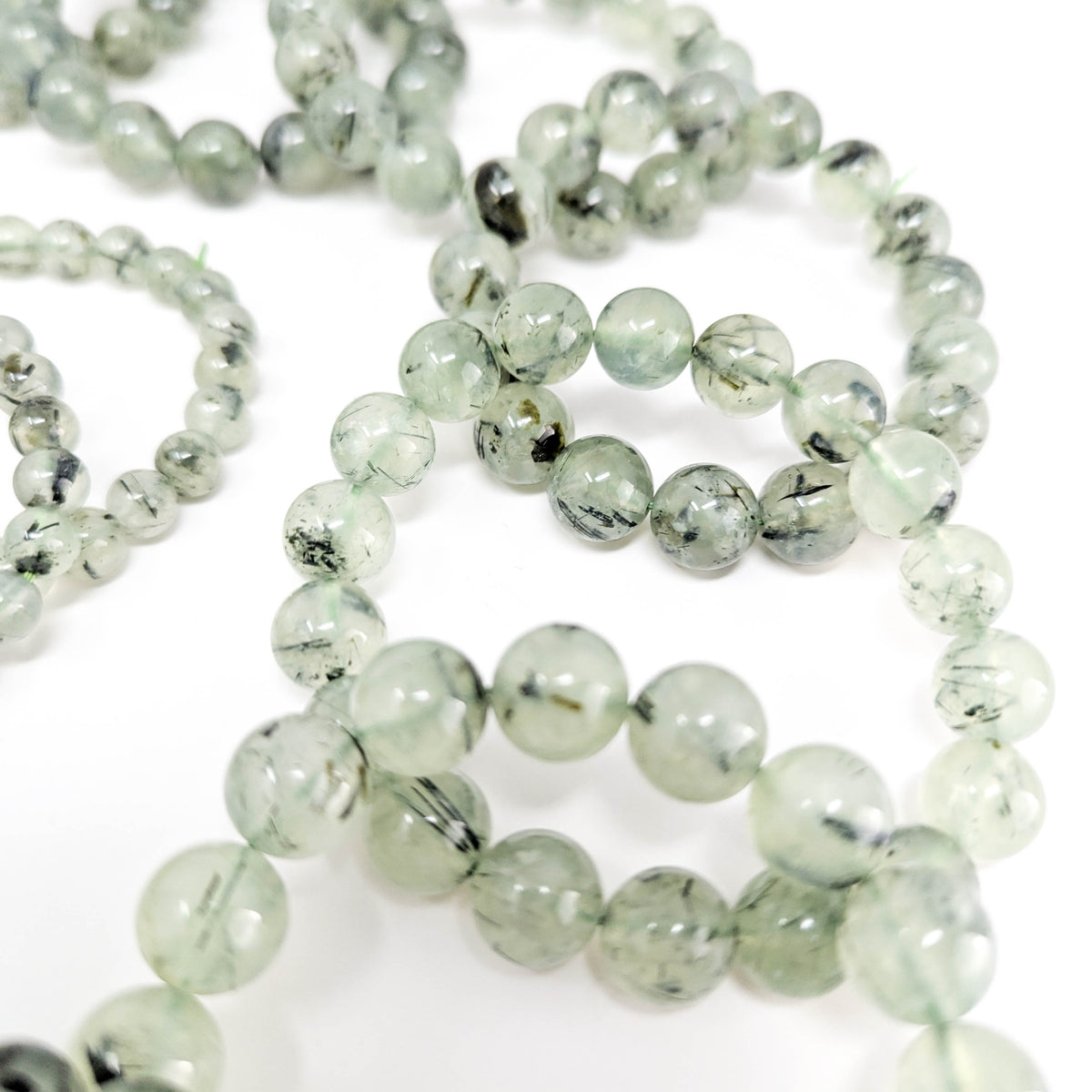 Prehnite with tourmaline bracelet: bead close up