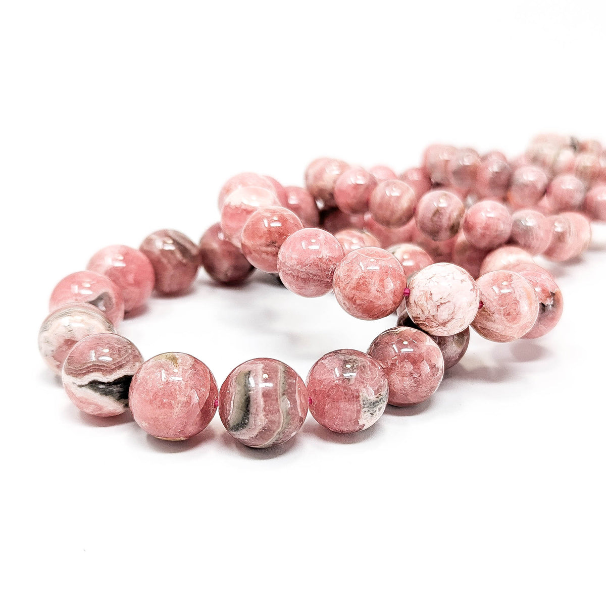 Rhodochrosite round bead bracelet – pile of bracelets
