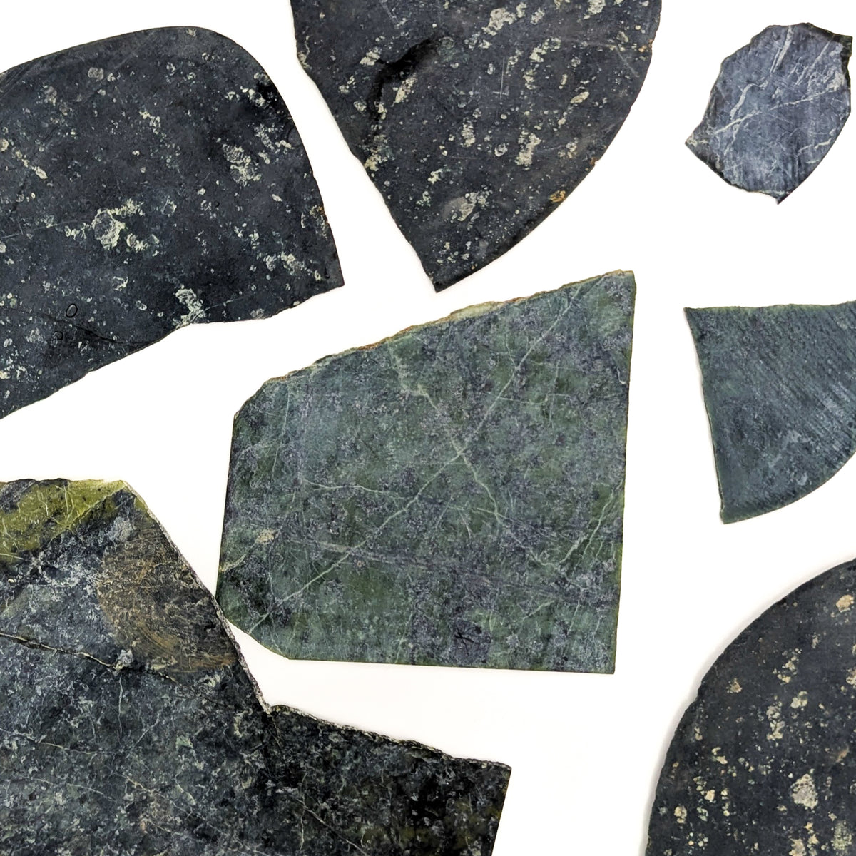 Thin cut serpentine rough from BC – scattered slices
