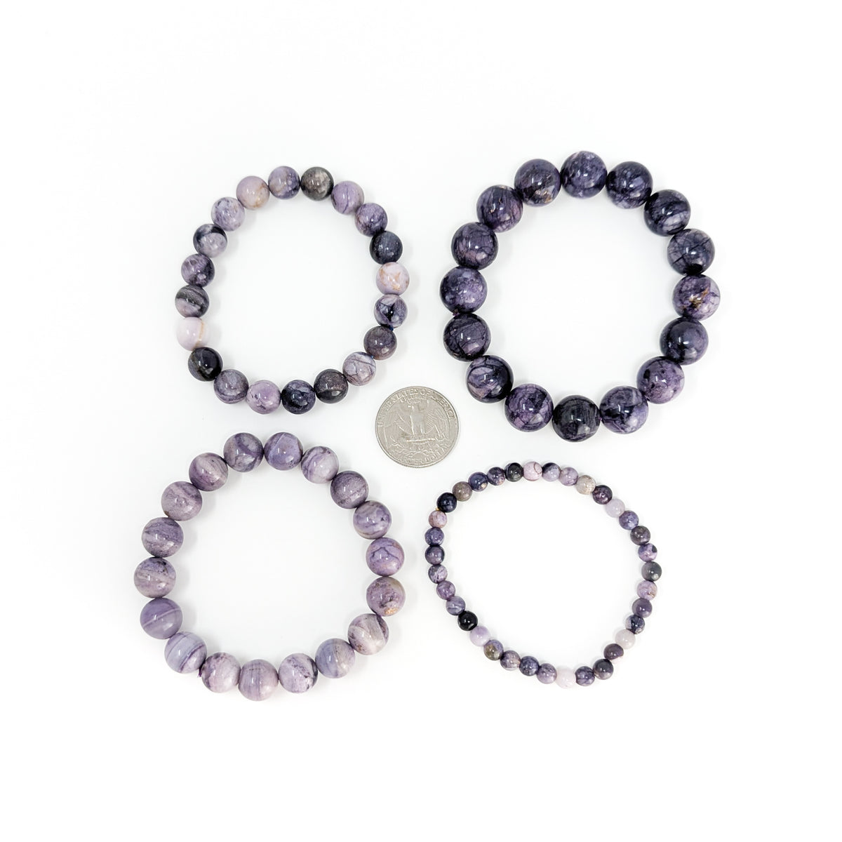 Tiffany stone bead bracelet: four bracelets beside a coin