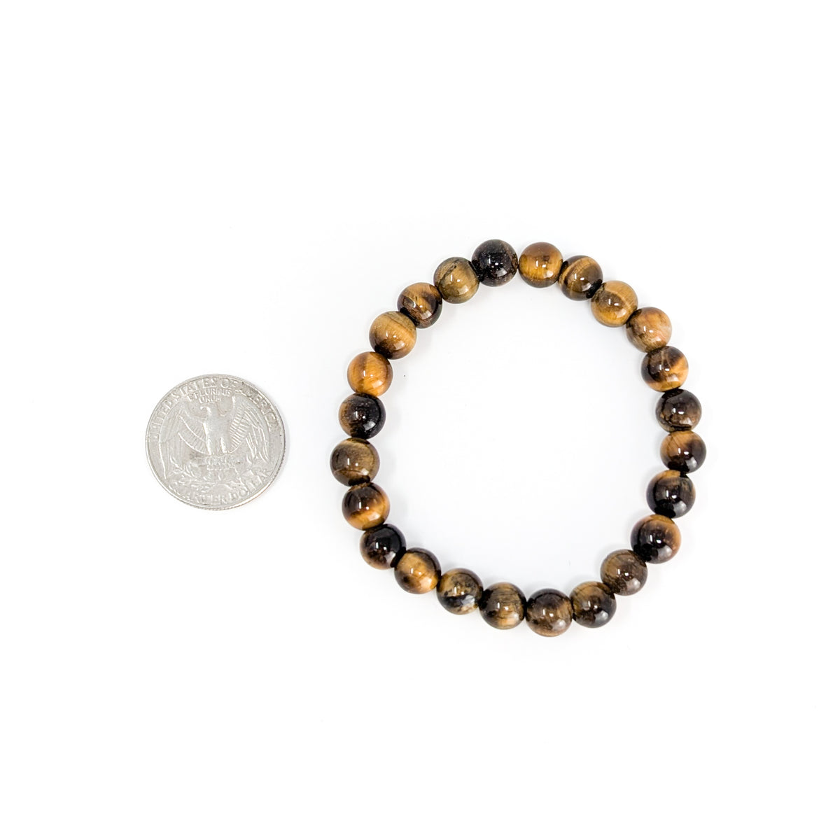 Tiger's eye bead bracelet from South Africa – bracelet beside a coin for scale