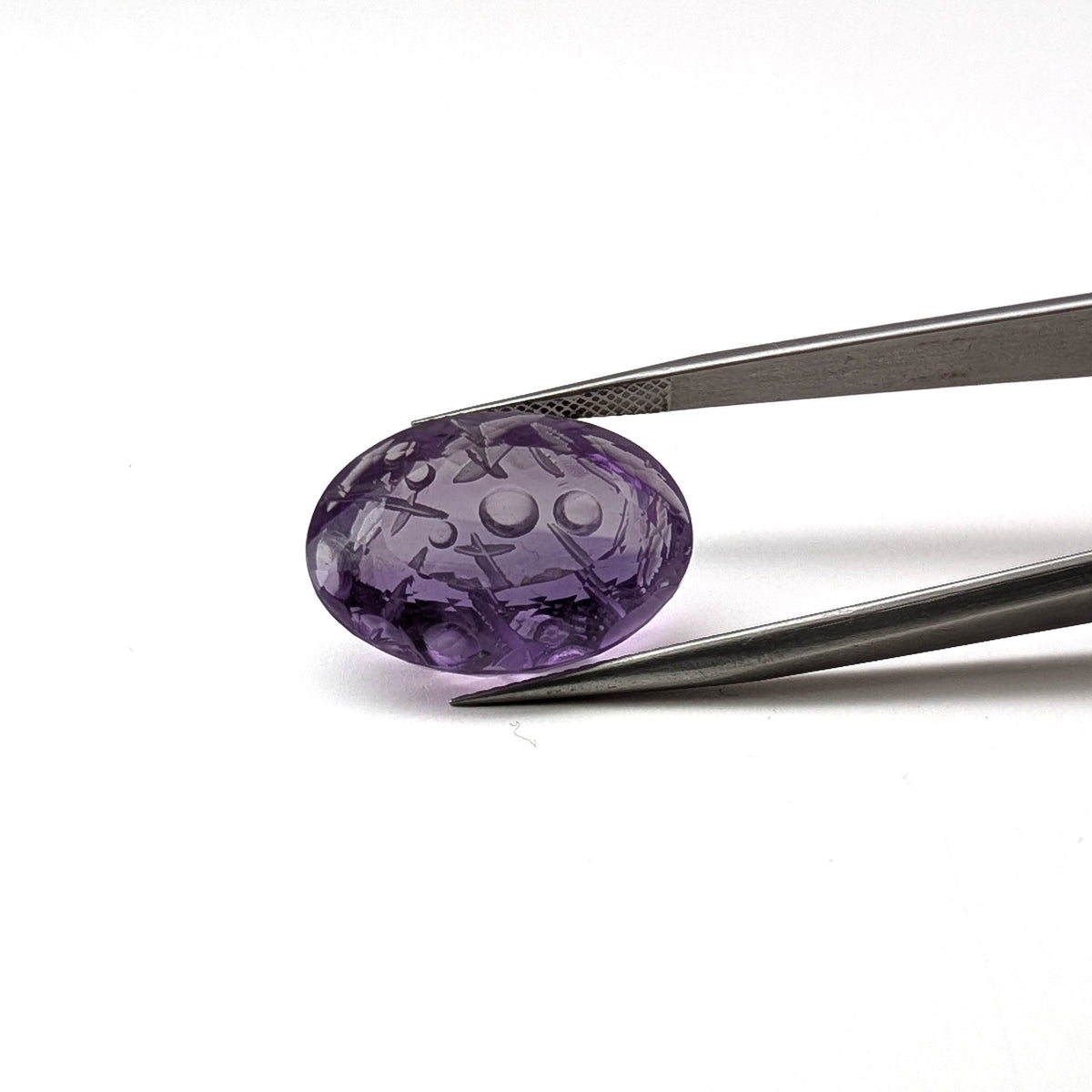 Amethyst faceted oval fantasy cut gemstone held in tweezers, 19.23ct, from Marabá, Pará, Brazil, view 14 of 15