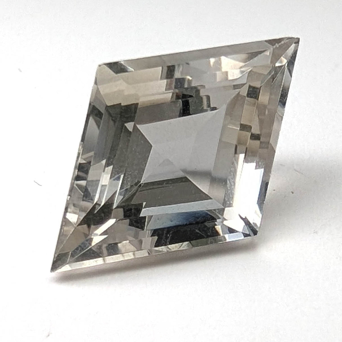 Clear quartz faceted lozenge gemstone, 9.36ct, from the King Citrine Mine, Mount Breakenridge, Harrison Lake, BC, Canada, on a white background, view 1 of 13