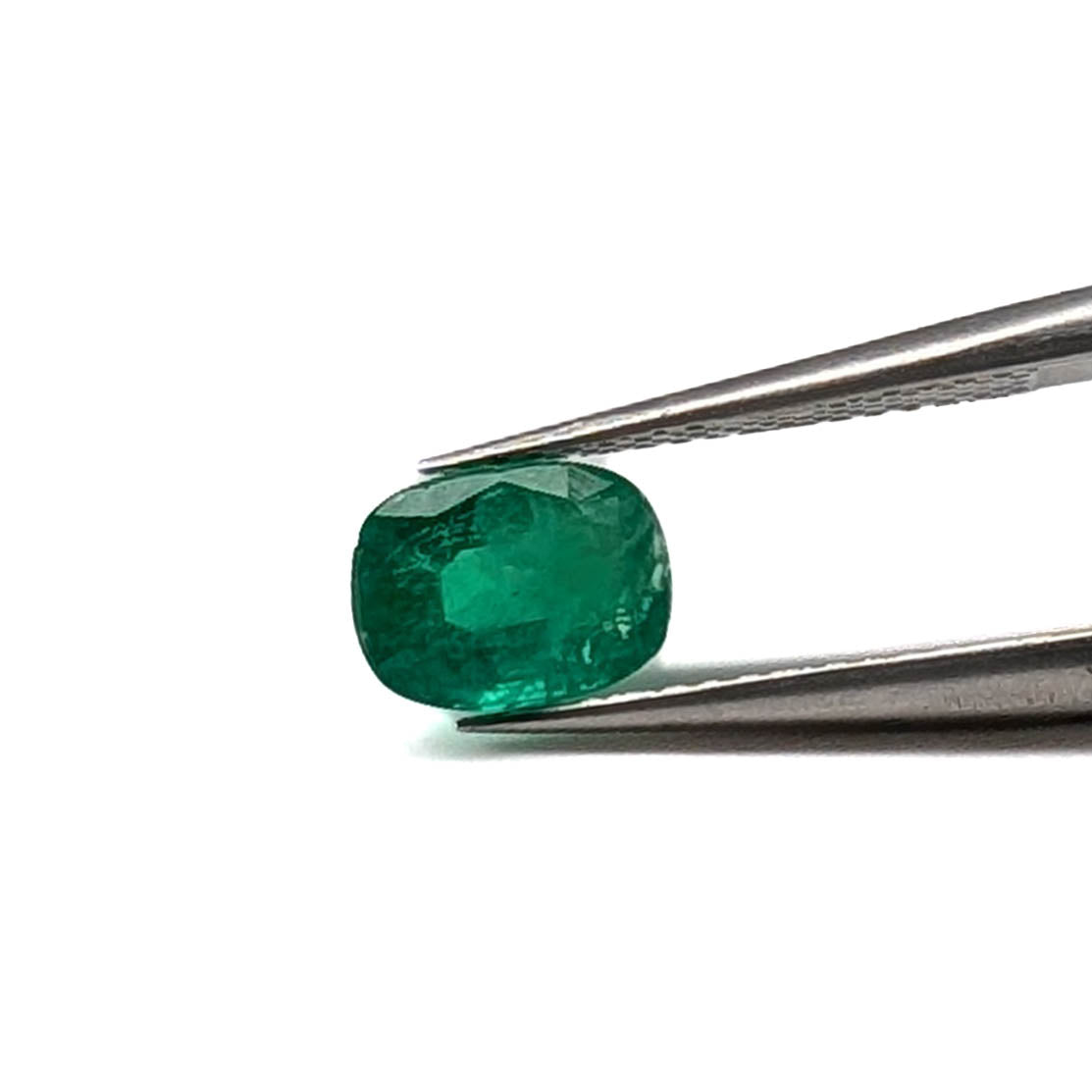 Emerald faceted cushion cut gemstone, 1.24ct, held in tweezers, view 2 of 11