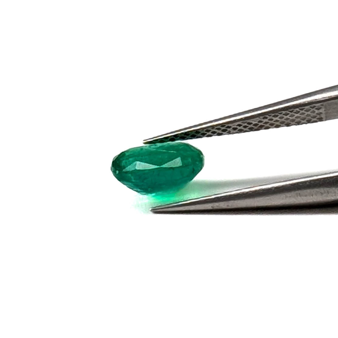 Emerald faceted cushion cut gemstone, 1.24ct, held in tweezers, view 11 of 11