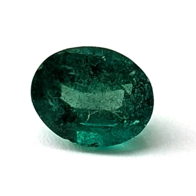 Emerald faceted oval gemstone, 0.73ct, face-up view of the table on a white background, view 1 of 10