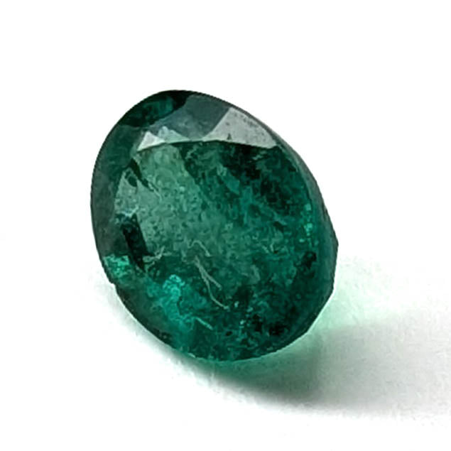 Emerald faceted oval gemstone, 0.73ct, angled view of the crown facets, view 3 of 10