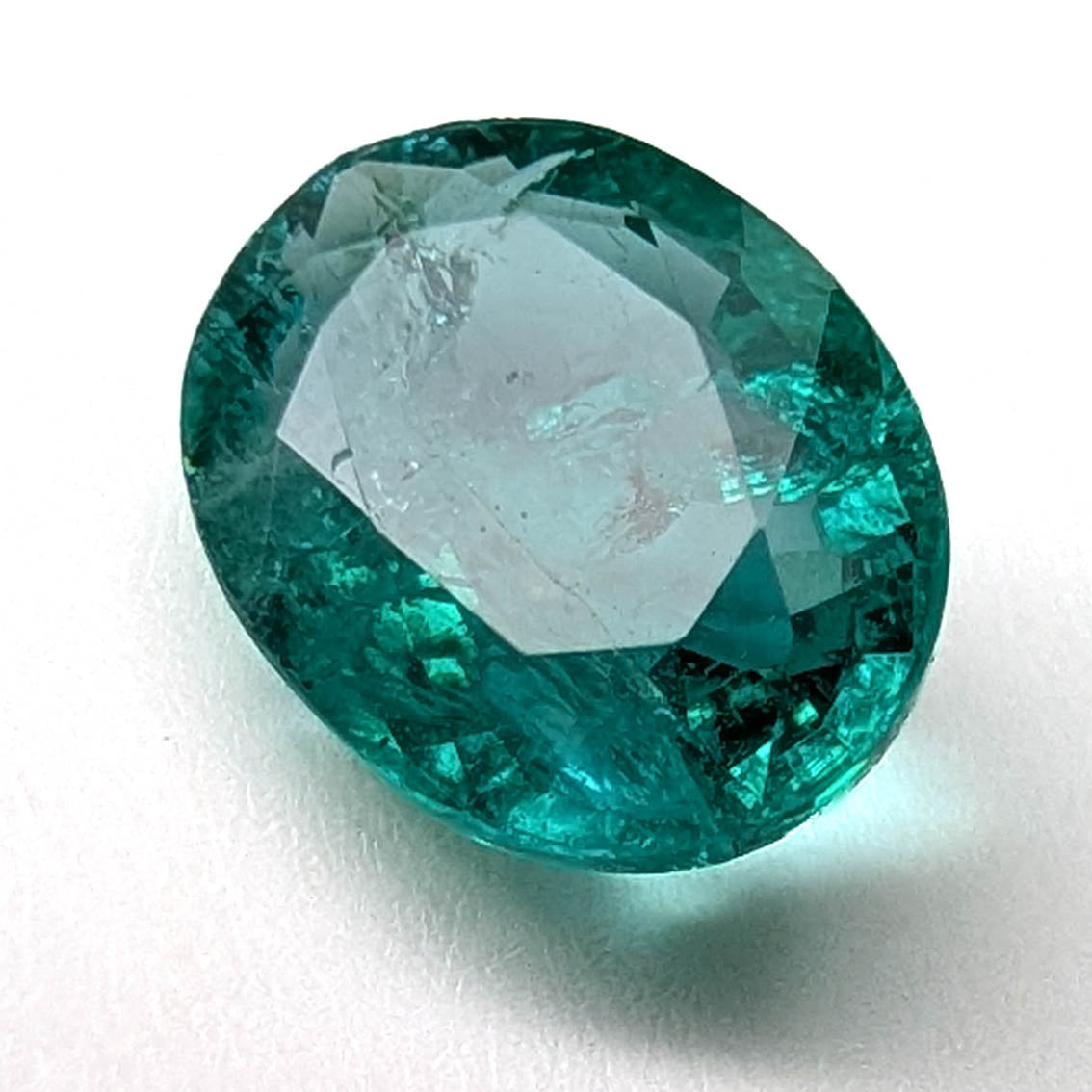 Emerald faceted oval gemstone, 1.90ct, close view of the face on a white background, view 9 of 13