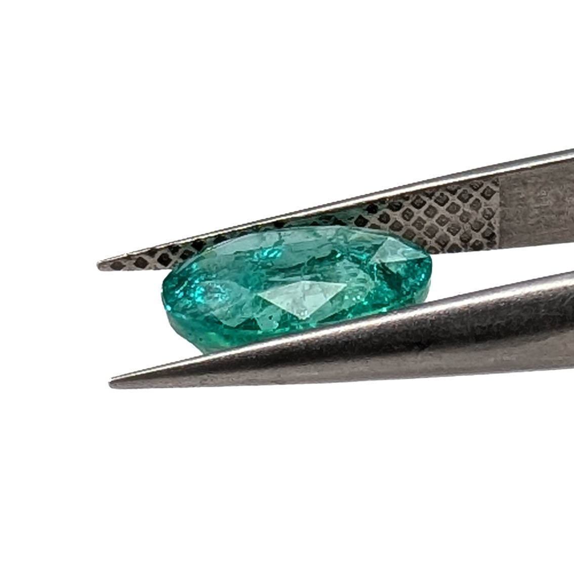 Emerald faceted oval gemstone, 1.90ct, held in tweezers, profile view, view 13 of 13