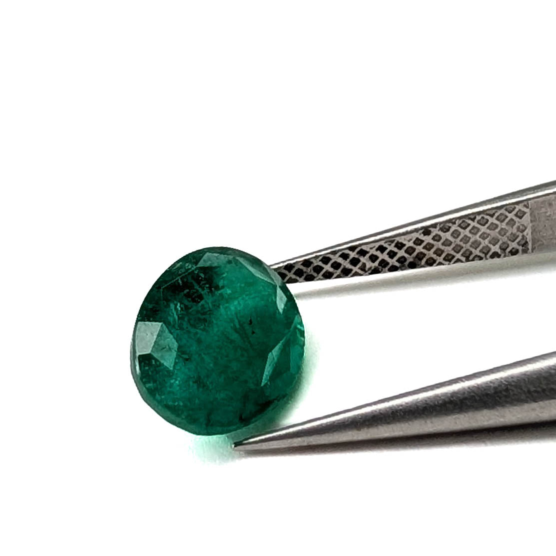 Emerald faceted oval gemstone, 1.92ct, held in tweezers, face-up, view 2 of 12