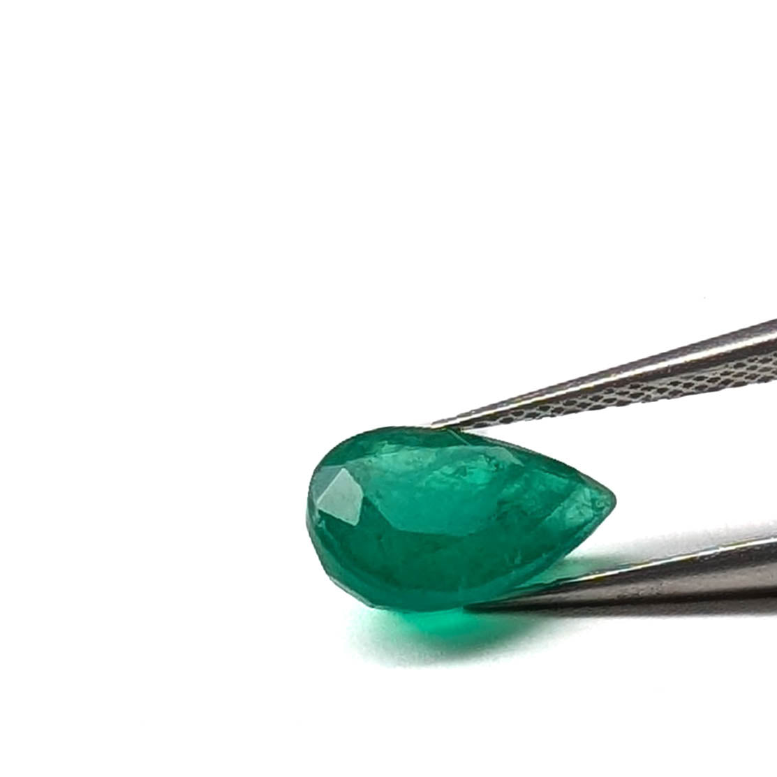 Emerald faceted pear cut gemstone, 2.10ct, held in tweezers, view 2 of 9