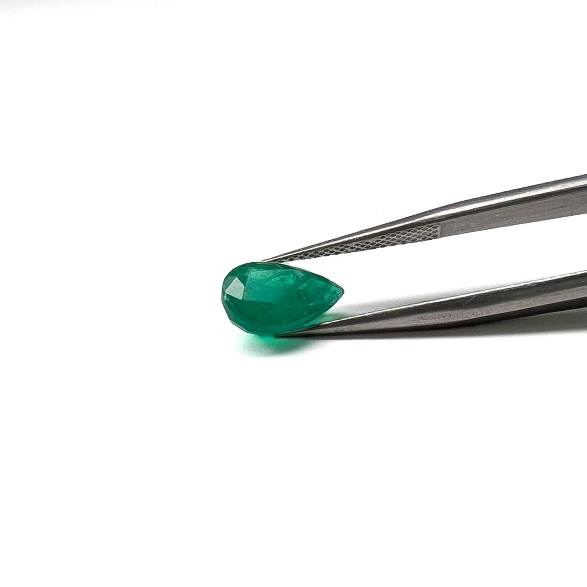 Emerald faceted pear cut gemstone, 2.10ct, held in tweezers, view 9 of 9