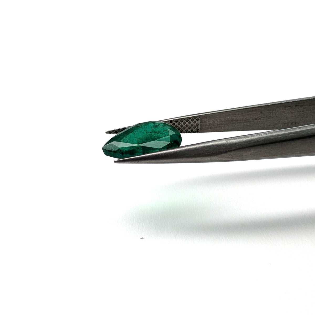 Emerald faceted pear cut gemstone, 2.36ct, held in tweezers, view 10 of 12