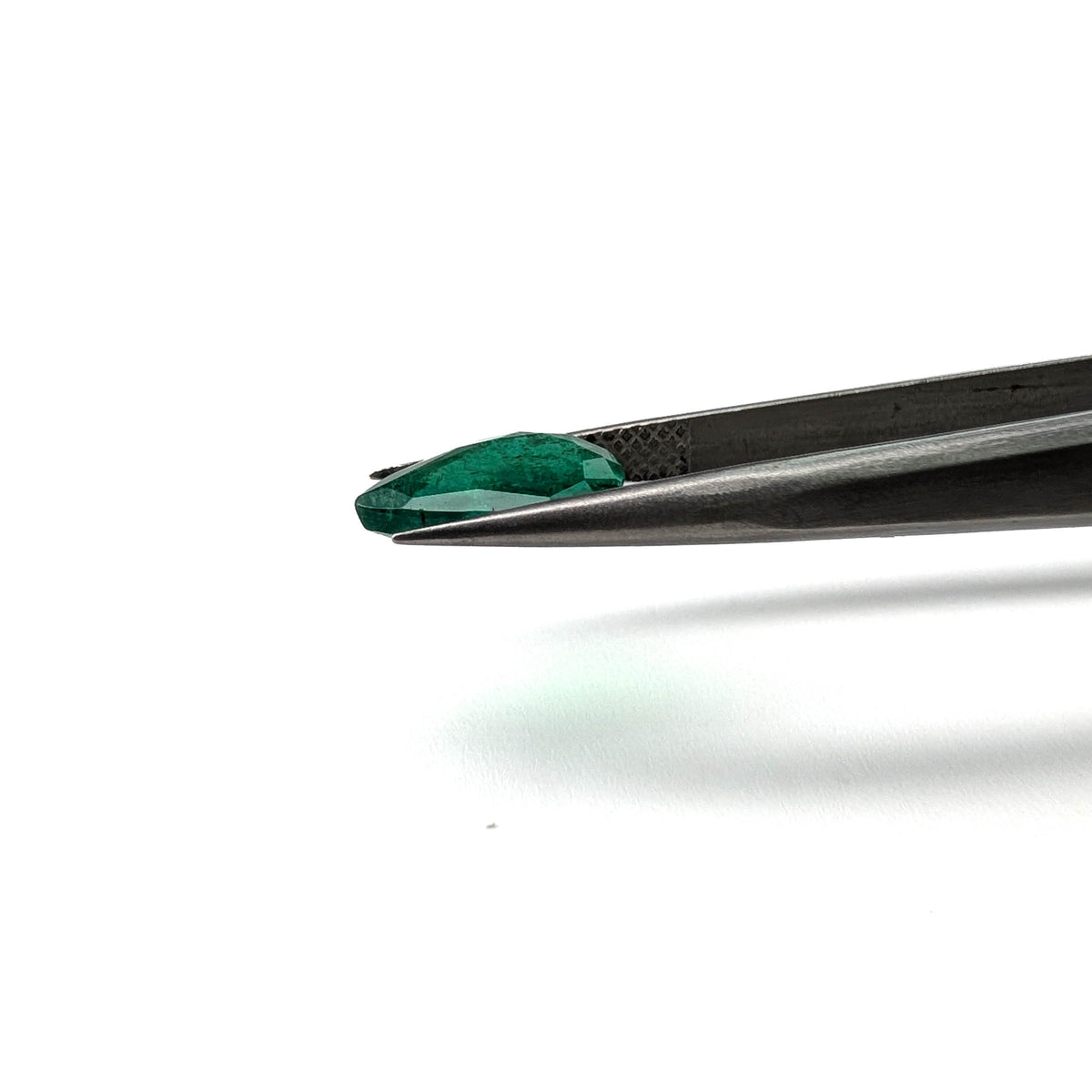 Emerald faceted pear cut gemstone, 2.36ct, held in tweezers, view 11 of 12