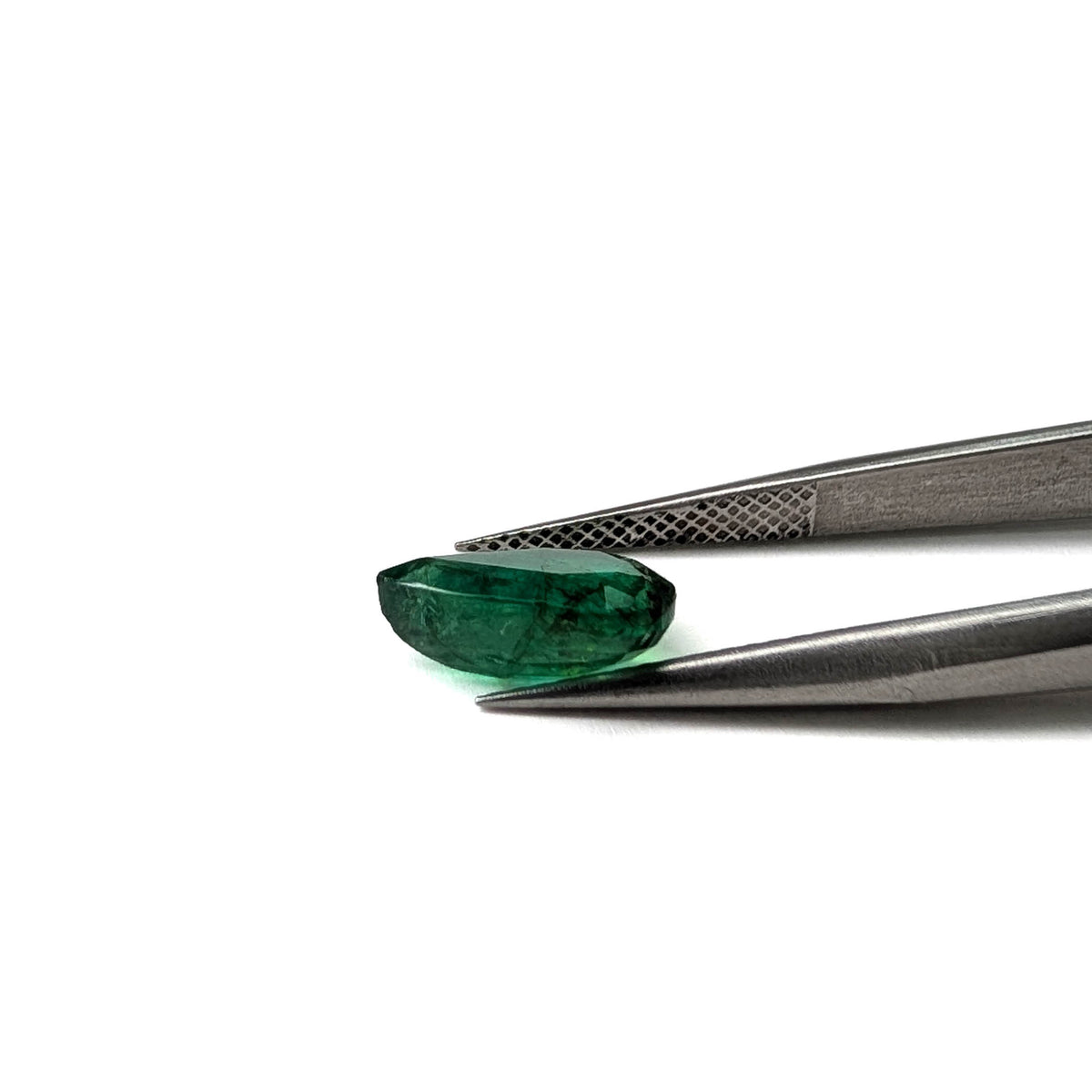 Emerald faceted pear cut gemstone, 2.47ct, held in tweezers, view 16 of 17