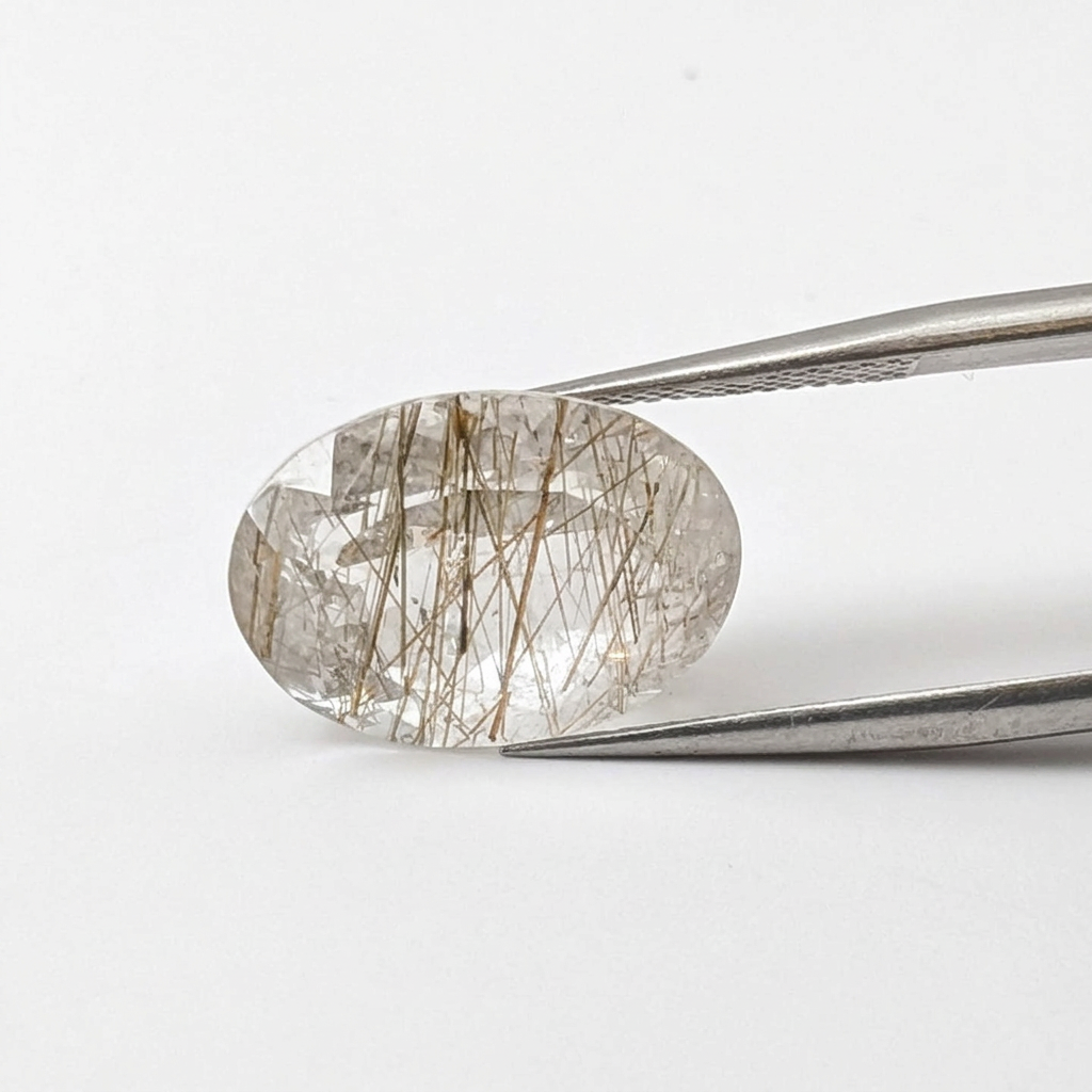 Actinolite quartz faceted oval gemstone, 10.80ct, from Mount Breakenridge, Harrison Lake, BC, Canada, held in tweezers, view 2 of 12