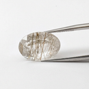 Actinolite quartz faceted oval gemstone, 10.80ct, from Mount Breakenridge, Harrison Lake, BC, Canada, held in tweezers, view 2 of 12