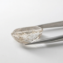 Actinolite quartz faceted oval gemstone, 17.09ct, from Mount Breakenridge, Harrison Lake, BC, Canada, held in tweezers, view 2 of 8