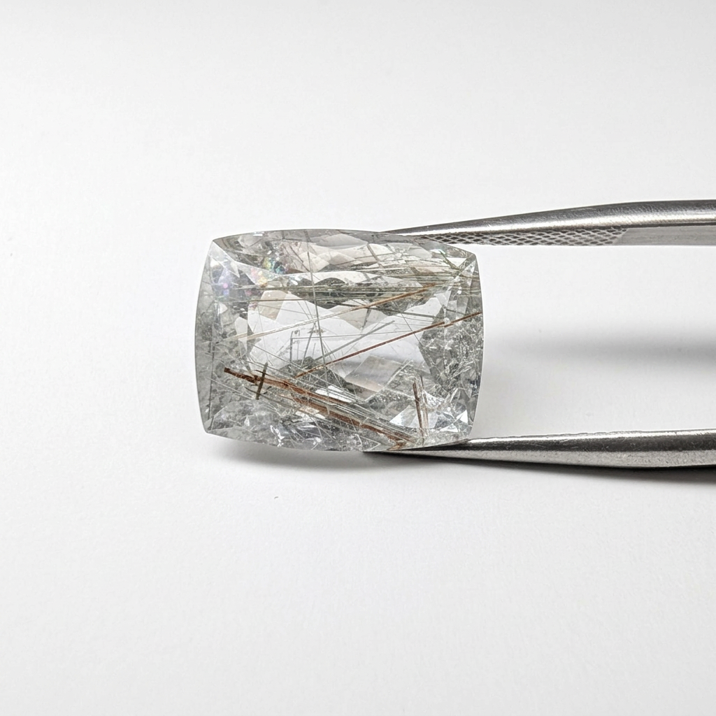 Actinolite quartz faceted cushion gemstone, 12.03ct, from Mount Breakenridge, Harrison Lake, BC, Canada, held in tweezers, view 2 of 12