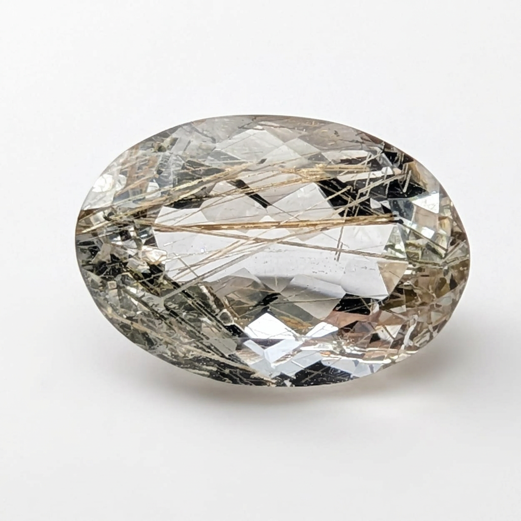 Actinolite quartz faceted oval gemstone, 3.65ct, from Mount Breakenridge, Harrison Lake, BC, Canada, on a white background, view 1 of 11