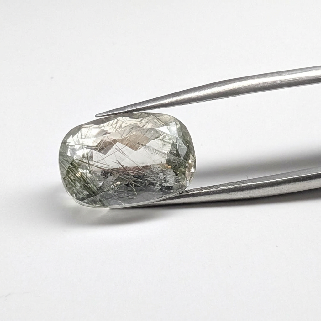 Actinolite quartz faceted cushion gemstone, 8.02ct, from Mount Breakenridge, Harrison Lake, BC, Canada, held in tweezers, view 2 of 11