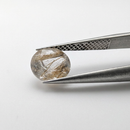 Actinolite quartz faceted round gemstone, 1.18ct, from Mount Breakenridge, Harrison Lake, BC, Canada, held in tweezers, view 8 of 10