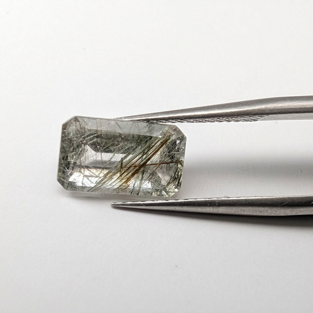 Actinolite quartz faceted emerald gemstone, 2.63ct, from Mount Breakenridge, Harrison Lake, BC, Canada, held in tweezers, view 2 of 11
