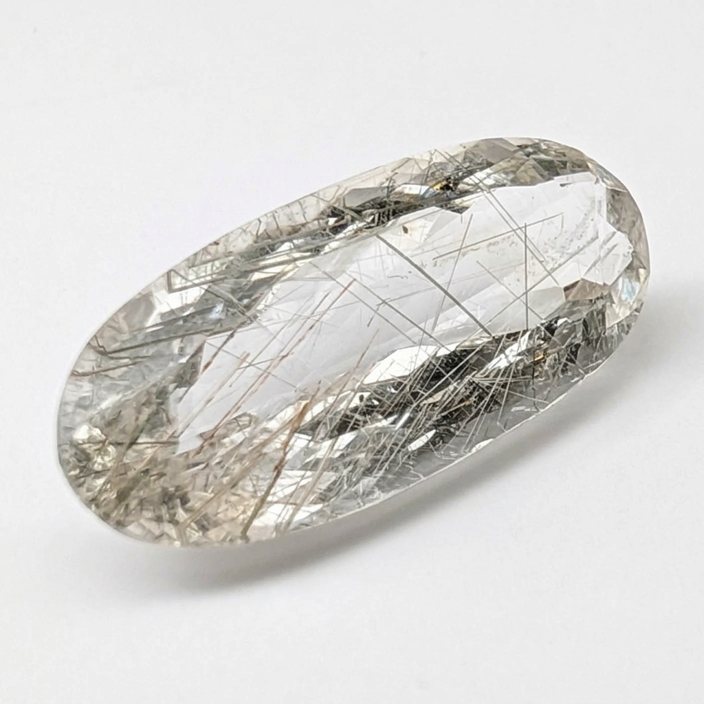 Actinolite quartz faceted oval gemstone, 15.08ct, from Mount Breakenridge, Harrison Lake, BC, Canada, on a white background, view 1 of 11