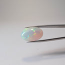 Ethiopian solid opal cabochon oval gemstone, 10.07ct, held in tweezers, view 2 of 8