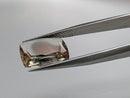 Oregon Sunstone faceted cushion cut gemstone, 4.50ct, from Plush, Oregon, held in tweezers, view 2 of 11