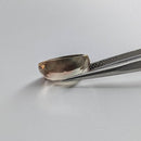Oregon Sunstone faceted cushion cut gemstone, 4.50ct, from Plush, Oregon, held in tweezers, view 3 of 11