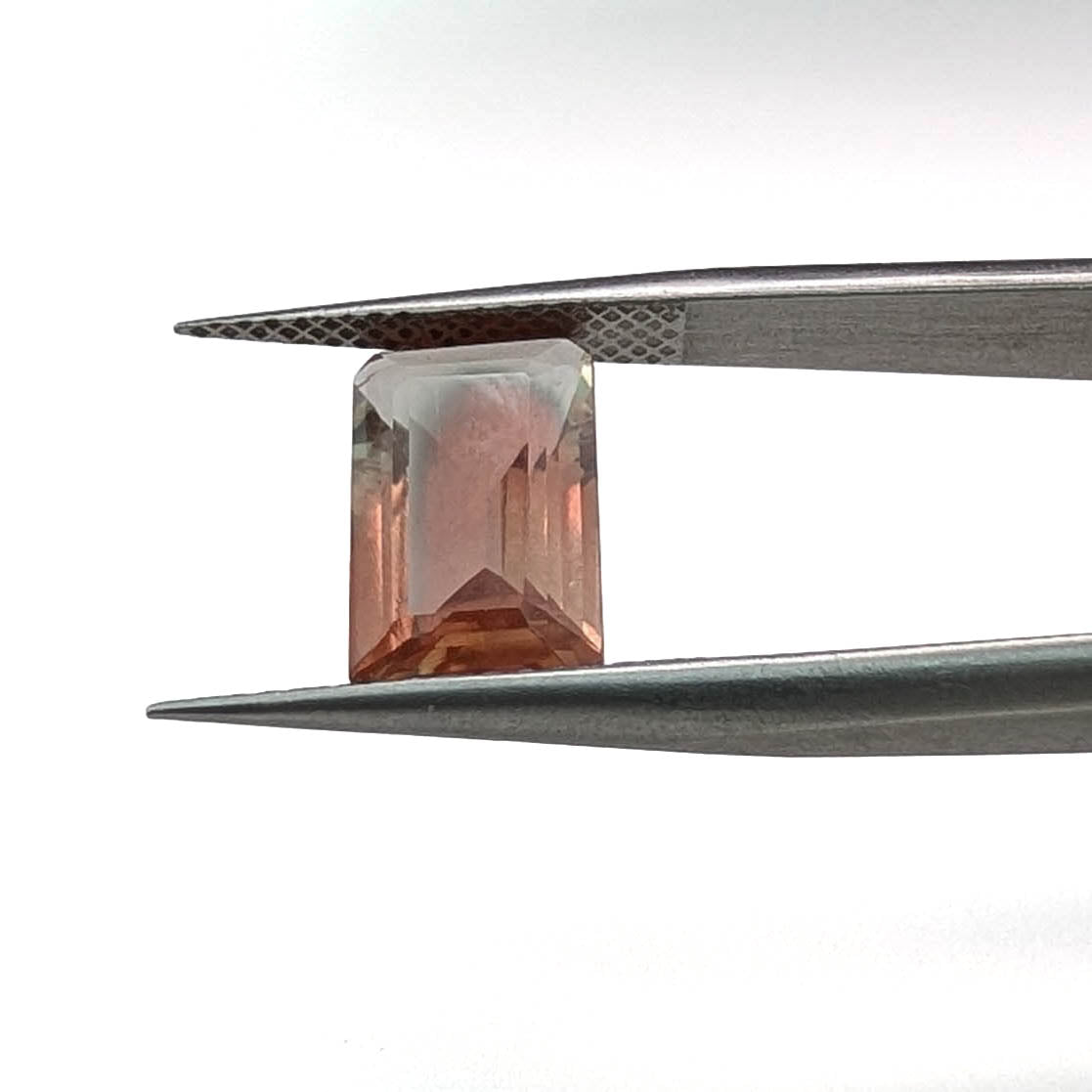 Oregon sunstone faceted emerald gemstone, 2.80ct, held in tweezers, view 2 of 11