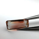 Oregon sunstone faceted emerald gemstone, 3.18ct, held in tweezers, view 2 of 9