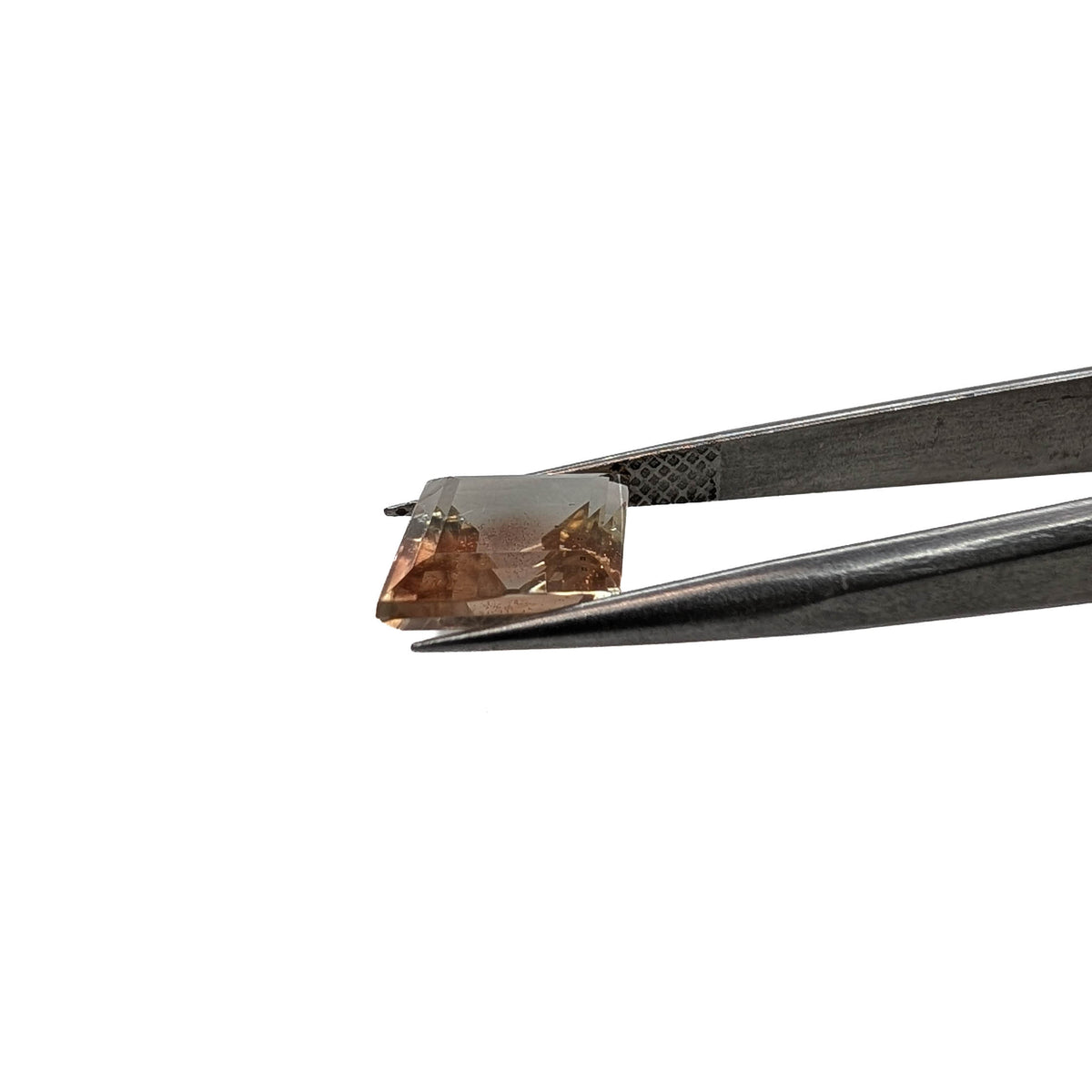 Oregon sunstone faceted lozenge gemstone, 3.42ct, held in tweezers, view 2 of 11