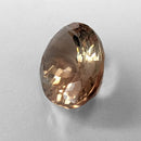 Oregon Sunstone faceted oval cut gemstone, 5.57ct, from Plush, Oregon, on a white background, view 7 of 11