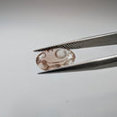 Oregon Sunstone faceted oval fantasy cut gemstone, 2.20ct, from Plush, Oregon, held in tweezers, view 3 of 11