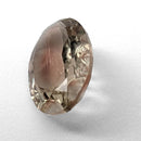 Oregon Sunstone faceted oval fantasy cut gemstone, 3.11ct, from Plush, Oregon, on a white background, view 7 of 15