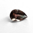 Oregon Sunstone faceted pear cut gemstone, 0.84ct, from Plush, Oregon, on a white background, view 1 of 9