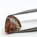 Oregon Sunstone faceted pear cut gemstone, 5.21ct, from Plush, Oregon, held in tweezers, view 3 of 12