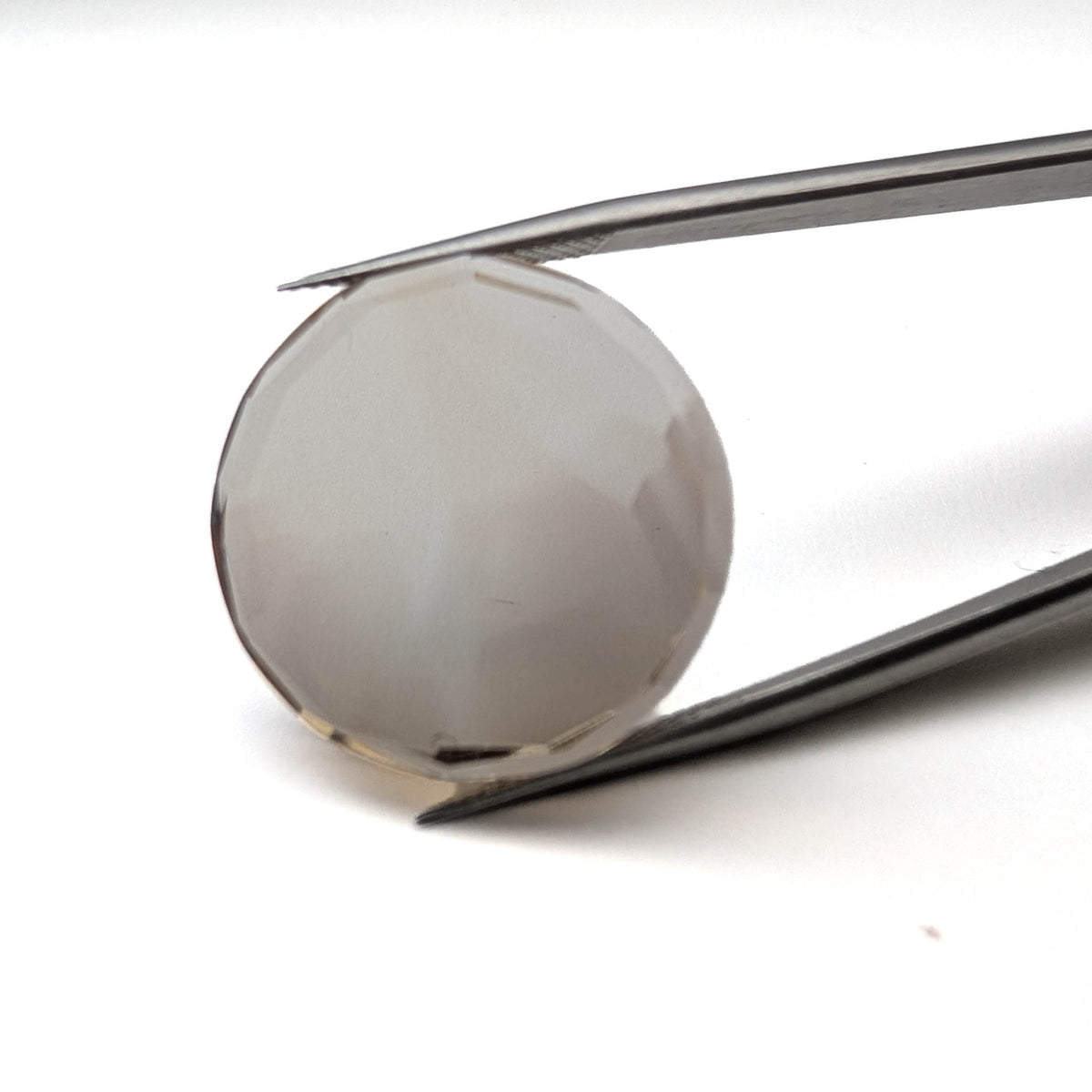 Smoky Quartz faceted round brilliant flatback gemstone, 21.80ct, from Minas Gerais, Brazil, held in tweezers, view 2 of 6