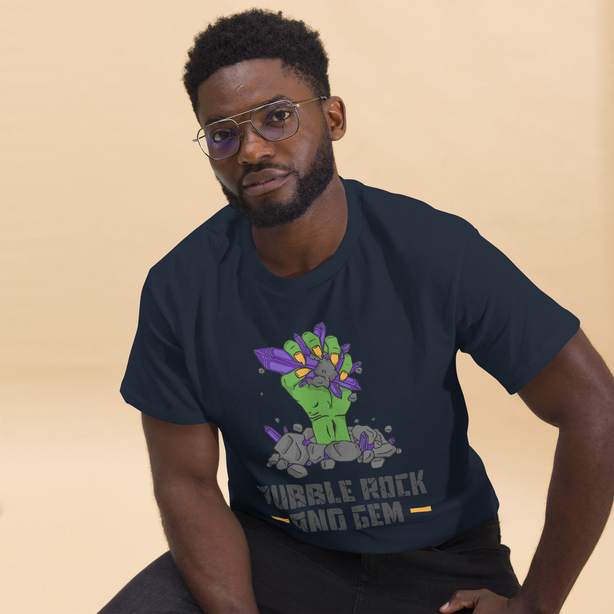 Rubble Rock and Gem classic logo tee – worn by man, seated
