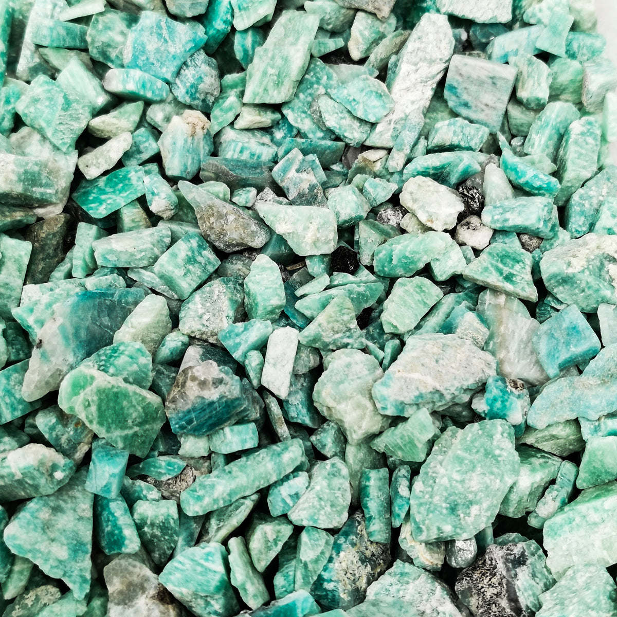 Amazonite Chips rough, a variety of microcline feldspar, from Brazil.