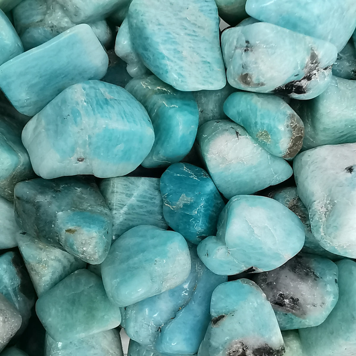 Amazonite tumble, a variety of microcline feldspar, from Madagascar.