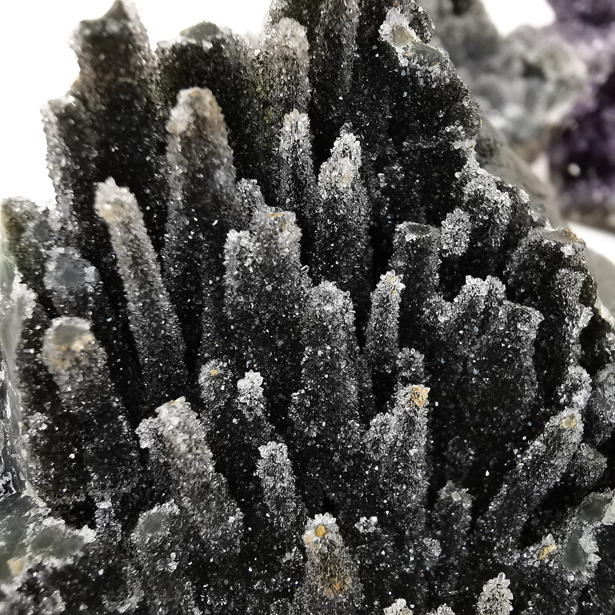 Black amethyst druzy from Uruguay – stalactite forms, close up