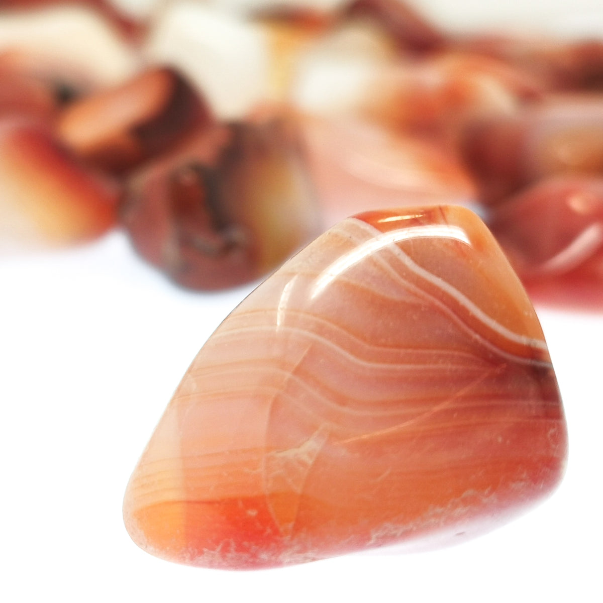 Carnelian B-grade tumble, a variety of chalcedony, from Ambato-Boeni District, Mahajanga Province, Madagascar.
